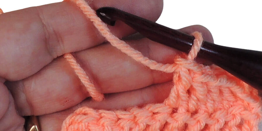 Photo showing step just explained for making a double crochet.