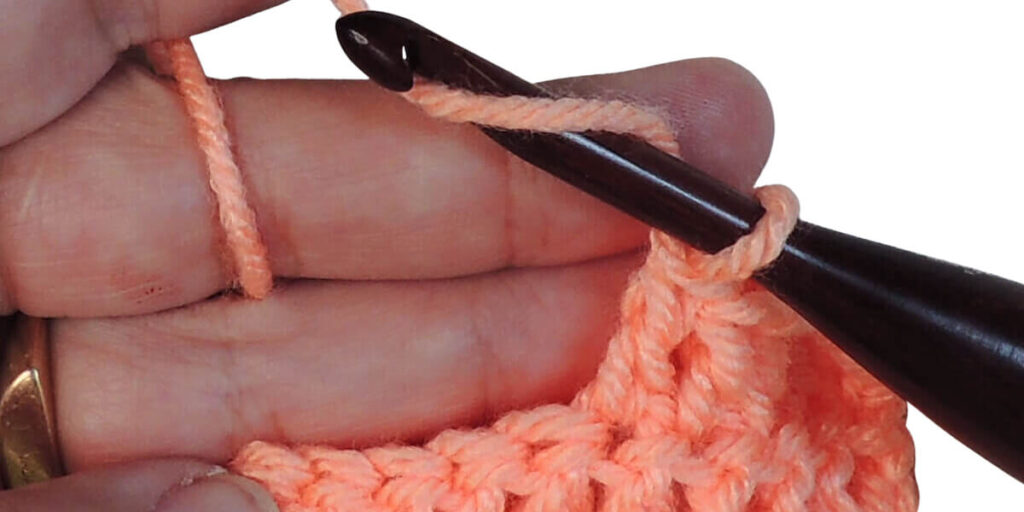 Photo showing step just explained for making a double crochet.