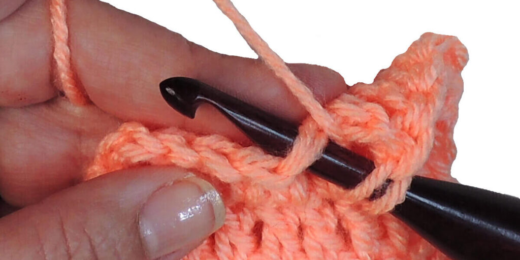 Photo showing step just explained for making a double crochet.