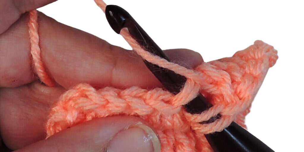 Photo showing step just explained for making a double crochet.