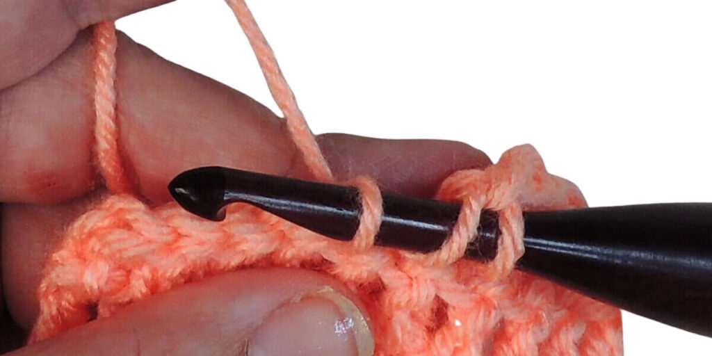 Photo showing step just explained for making a double crochet.
