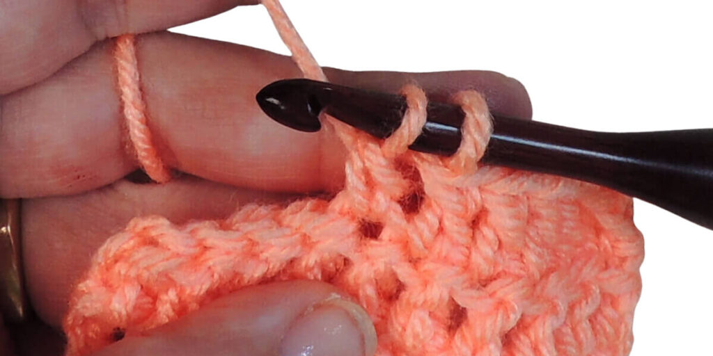 Photo showing step just explained for making a double crochet.