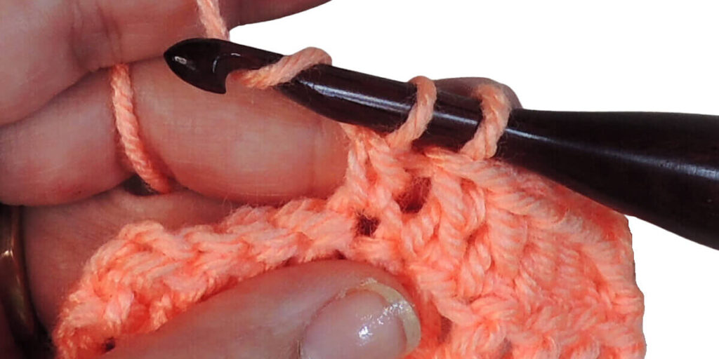 Photo showing step just explained for making a double crochet.