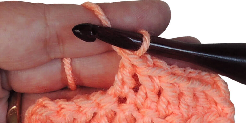 Photo showing step just explained for making a double crochet.