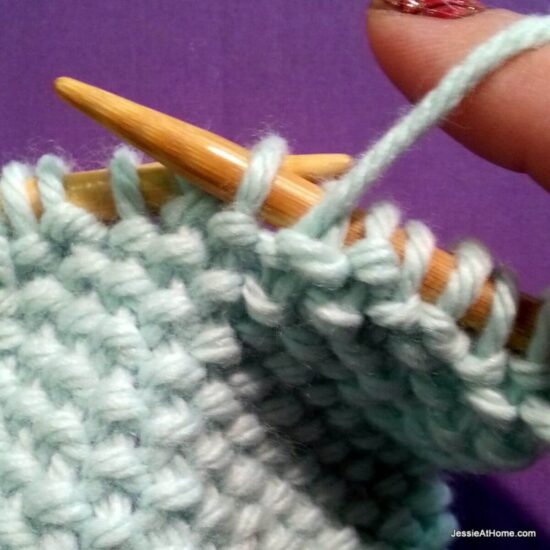 Photo showing step just explained of knit linen stitch.