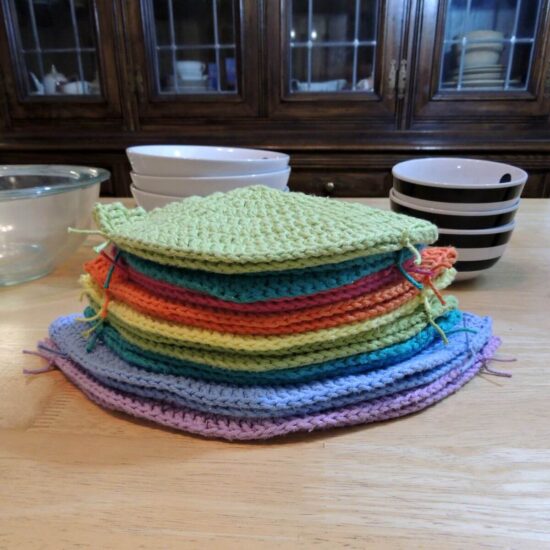 Image of a stack of crochet bowl cozies stacked on top of each other.