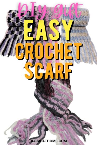 White vertical rectangle with an image of 3 scarves, each rolled up, on the top half. On the bottom half is an image of one of the scarves being worn by a mannequin head, over top of the top half is the text "DIY Gift Easy Crochet Scarf", and across the very bottom is the text "Jessie At Home dot com."