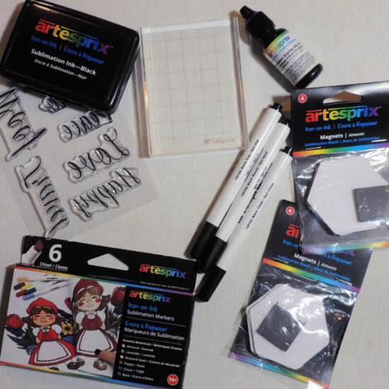 flat lay photo of markers, stamps, ink pad, stamp block, and hexagon magnate blanks