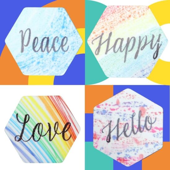 Four hexagon magnets that say "Love", "Hello", "Peace" & "Happy", all on a colorful background