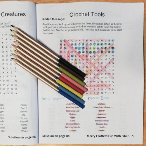 Photo of an activity book page. Page has a crochet tools word search which has been solved with colored pencils.