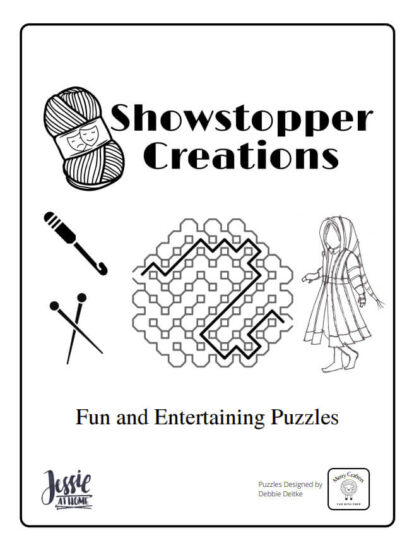 Image of the cover of an activity book with a graphic of a yarn skein with comedy & tragedy masks on the wrapper and text "showstopper creations", along with graphics of a crochet hook, knitting needles a maze, and a child in a coat. Below that is text "fun and entertaining puzzles." At the bottom are logos of Jessie At Home and Merry Cafters fun with Fiber, and text "puzzles designed by Debbie Deitke."