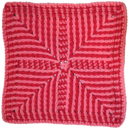 Two tone pink crochet square with angled stripes pointing in from corners made with post stitches.