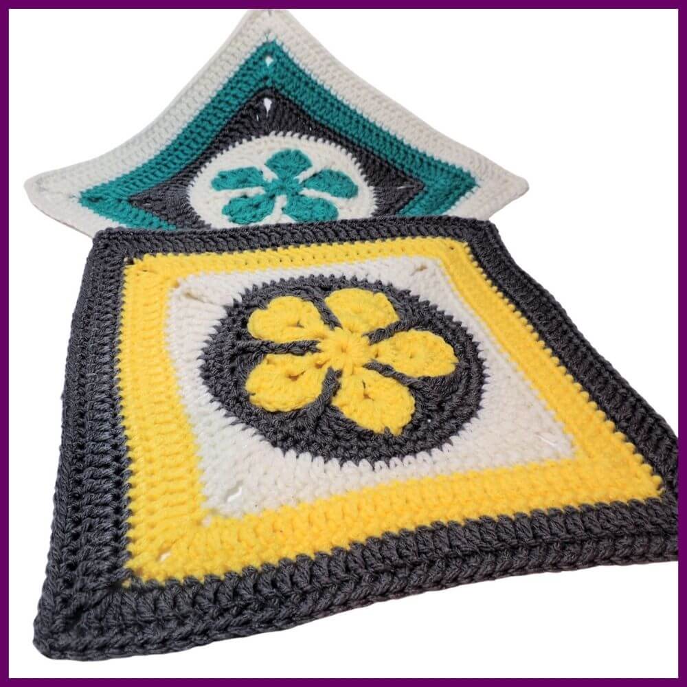 White square image, in back is a crochet square at an angle with a teal 5 point flower in a white circle in the center, then a round of gray to make a square, followed by rounds in teal than white. In front is a second square in yellow, gray, and white.