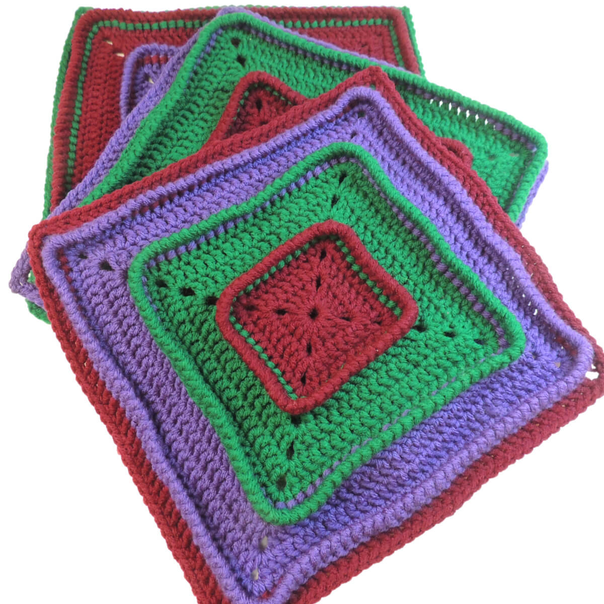 Three crochet squares stacked and slightly spread at a diagonal. Top square starts with burgundy on the inside, then has a section of green, then purple, then burgundy, each attached below the last round of the section before, making the last round stand up. Other 2 squares are the same with the colors in a different order.