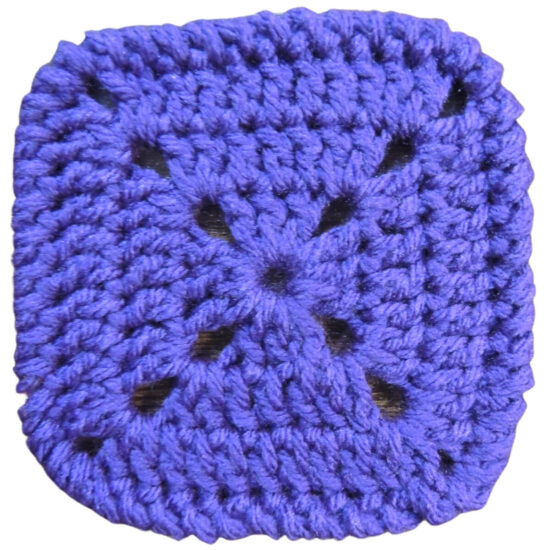 Purple square made in double crochet with a finished wrap-look edge.