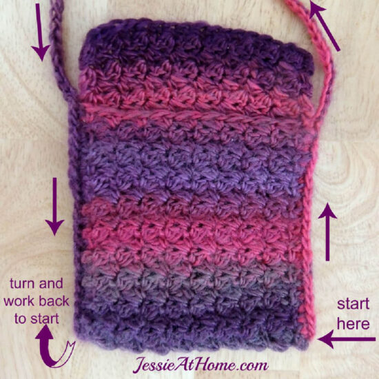 Close up of a small rectangular crochet bag in dark pink and purple color changing yarn. Along edges are arrows and text showing the direction of adding the straps. They start at the bottom right, go up the side of the bag then make the strap, then come back down the left side of the bag. Then the arrows tell you to turn and work the whole thing back to the start. Along bottom is text "Jessie At Home dot com."
