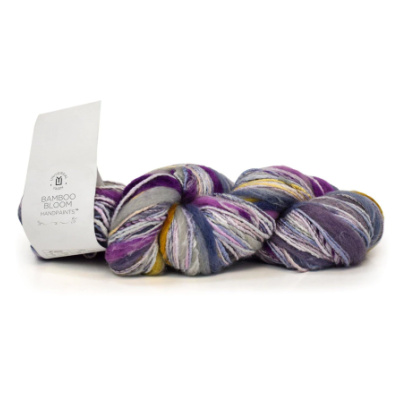 One twisted hank of Universal Yarn Bamboo Bloom Handpaints in muted multi-colors