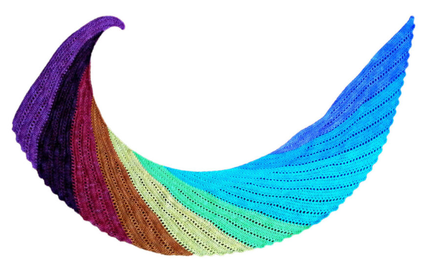 Flay lay photo of a curved long crochet wrap or shawl resembling a bird wing in rainbow colors starting with purple and ending with blue.